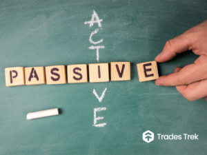 Scrabble pieces that spell the word passive with the word active written with a chalk cutting across on a board with the Trades Trek Logo