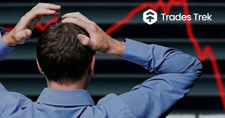 A man, watching his investment portfolio go down in value. Learn how to avoid losing money on the stock market with trades trek